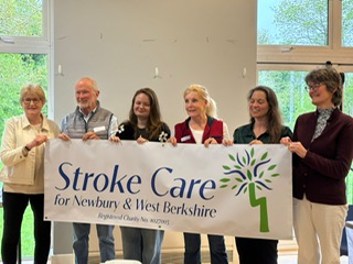 Trustees of Stroke Care for Newbury and West Berkshire holding the charity banner