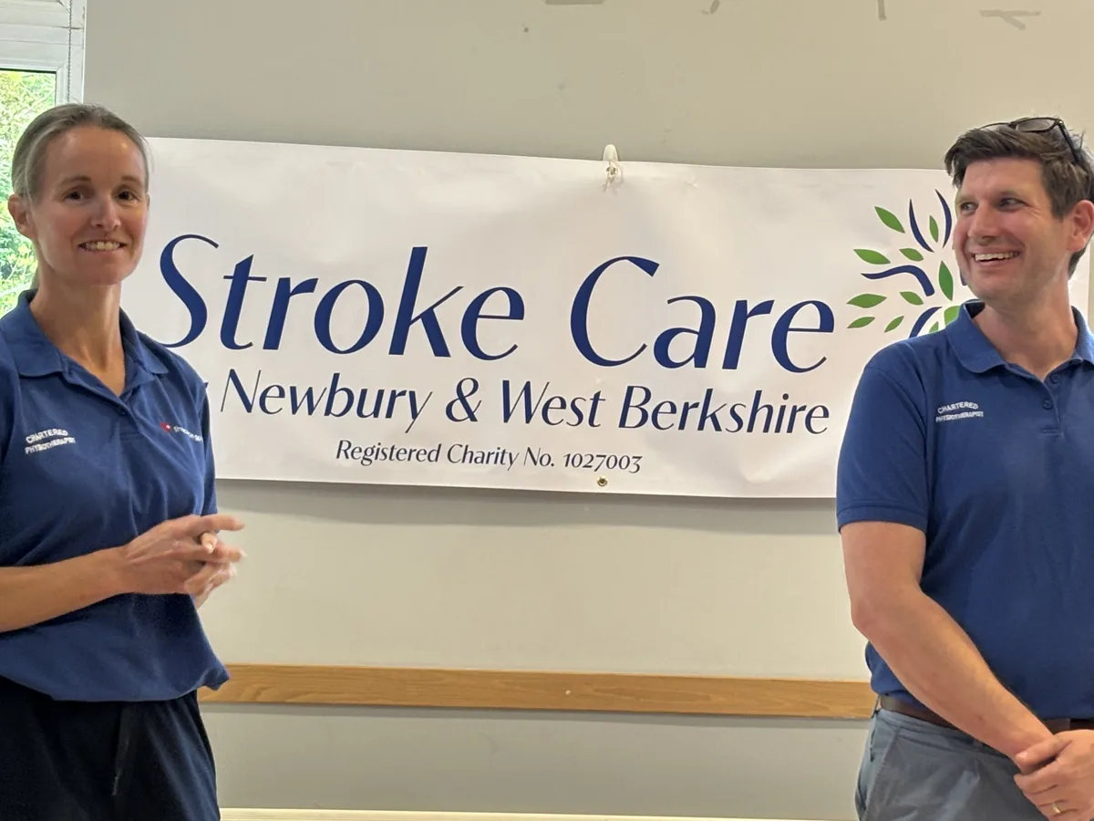 Newbury 8 Vicky H. and Will Ferguson smiling in front of the Stroke Care for Newbury and West Berkshire banner at the charity’s AGM